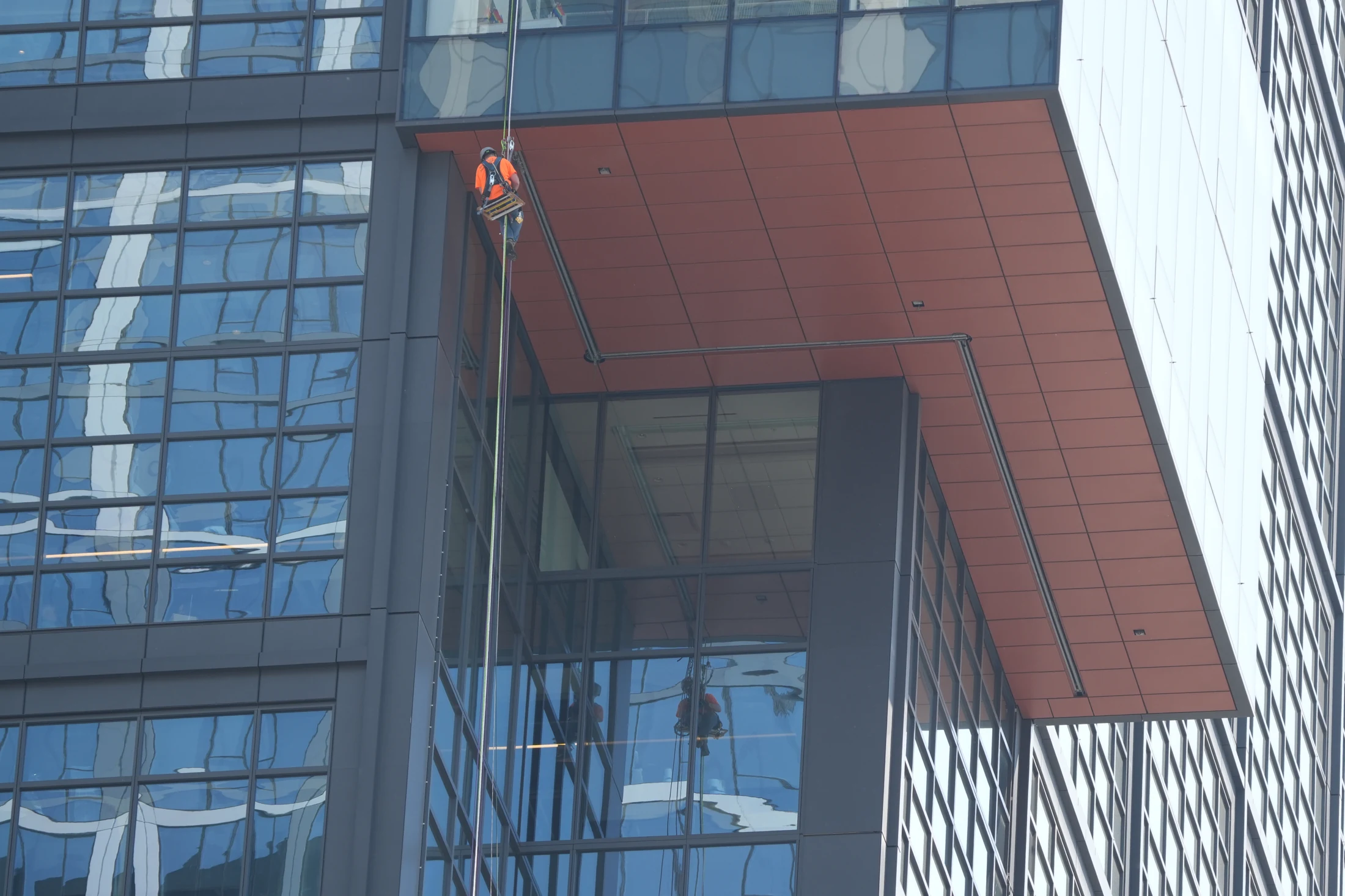 Suspended access work along the glass façade at 100 Causeway Street in Boston