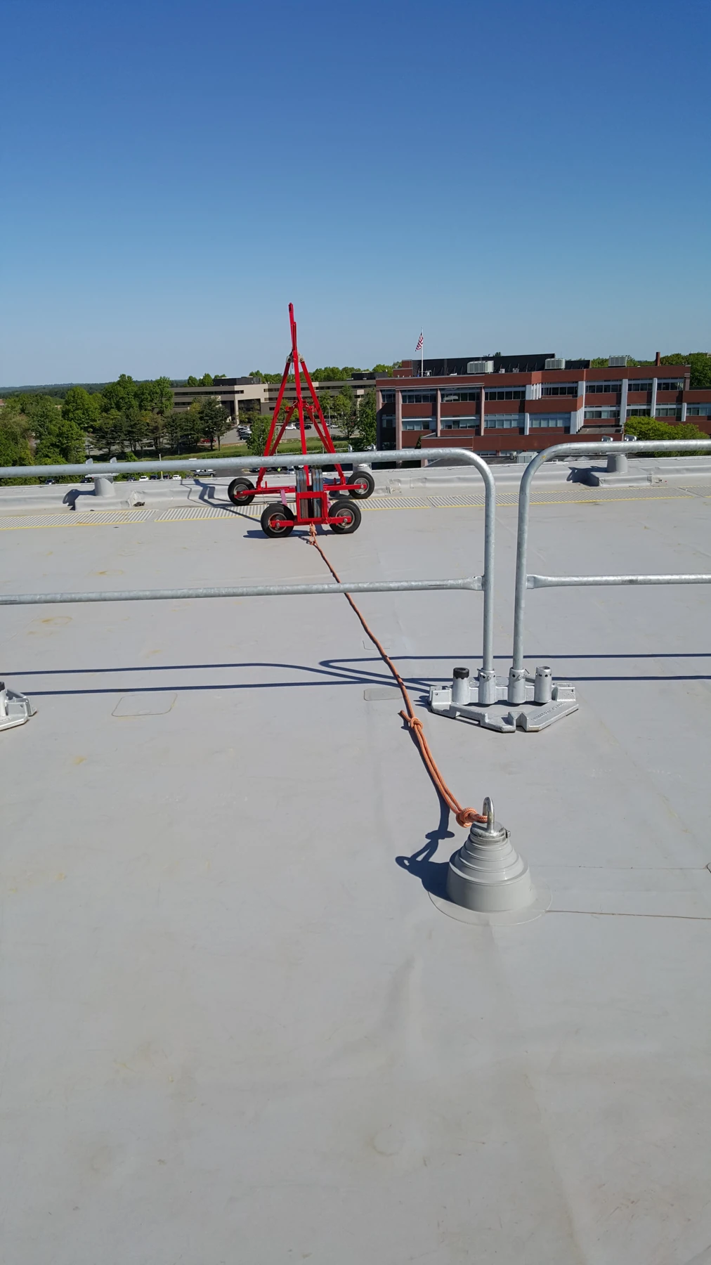 Roof-side outrigger for chair work tied back to a permanent anchor.