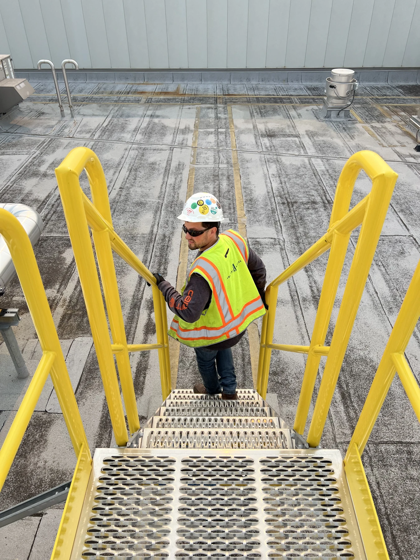 Installed roof stair and platform access with a worker.
