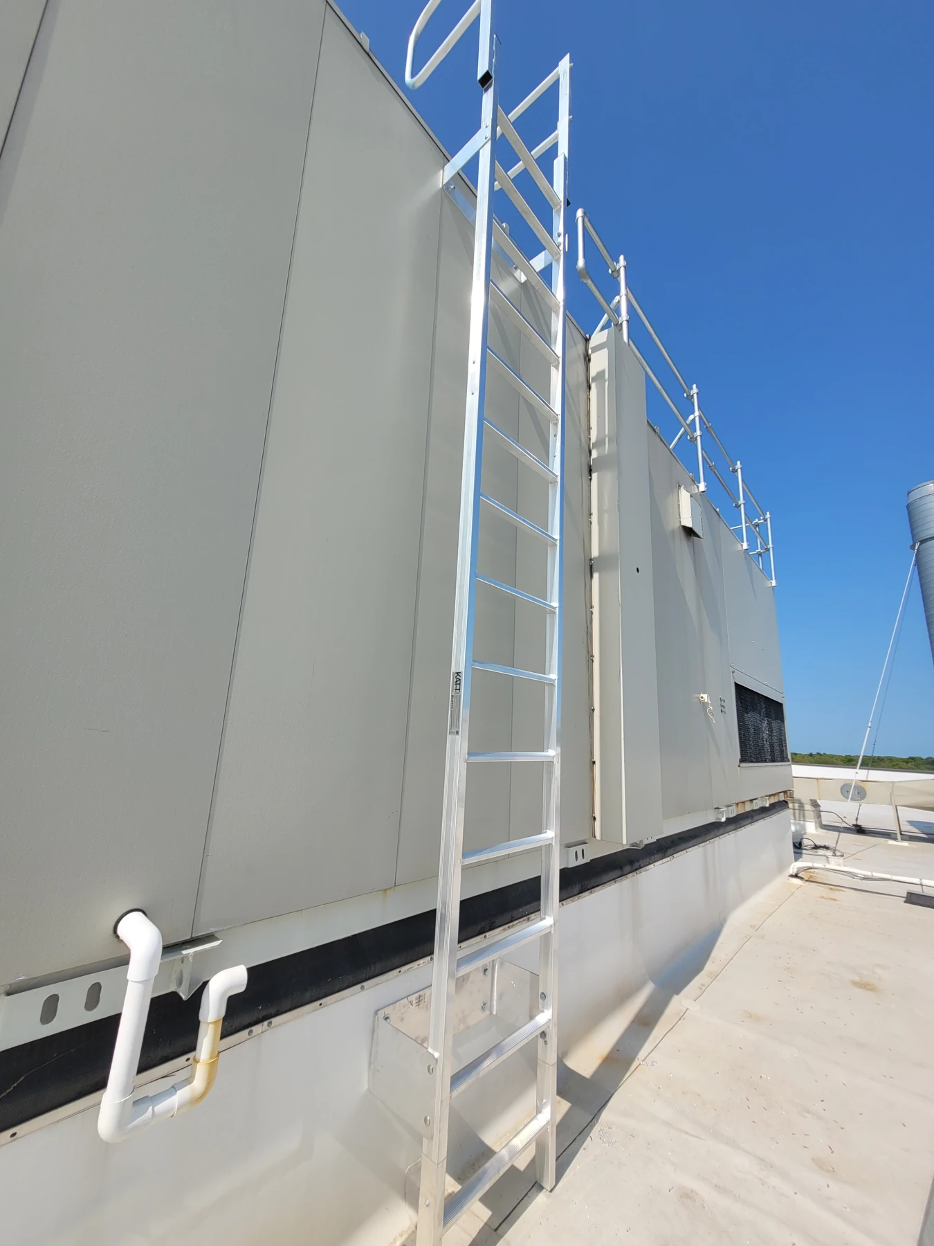 Installed fixed ladder between roof levels.