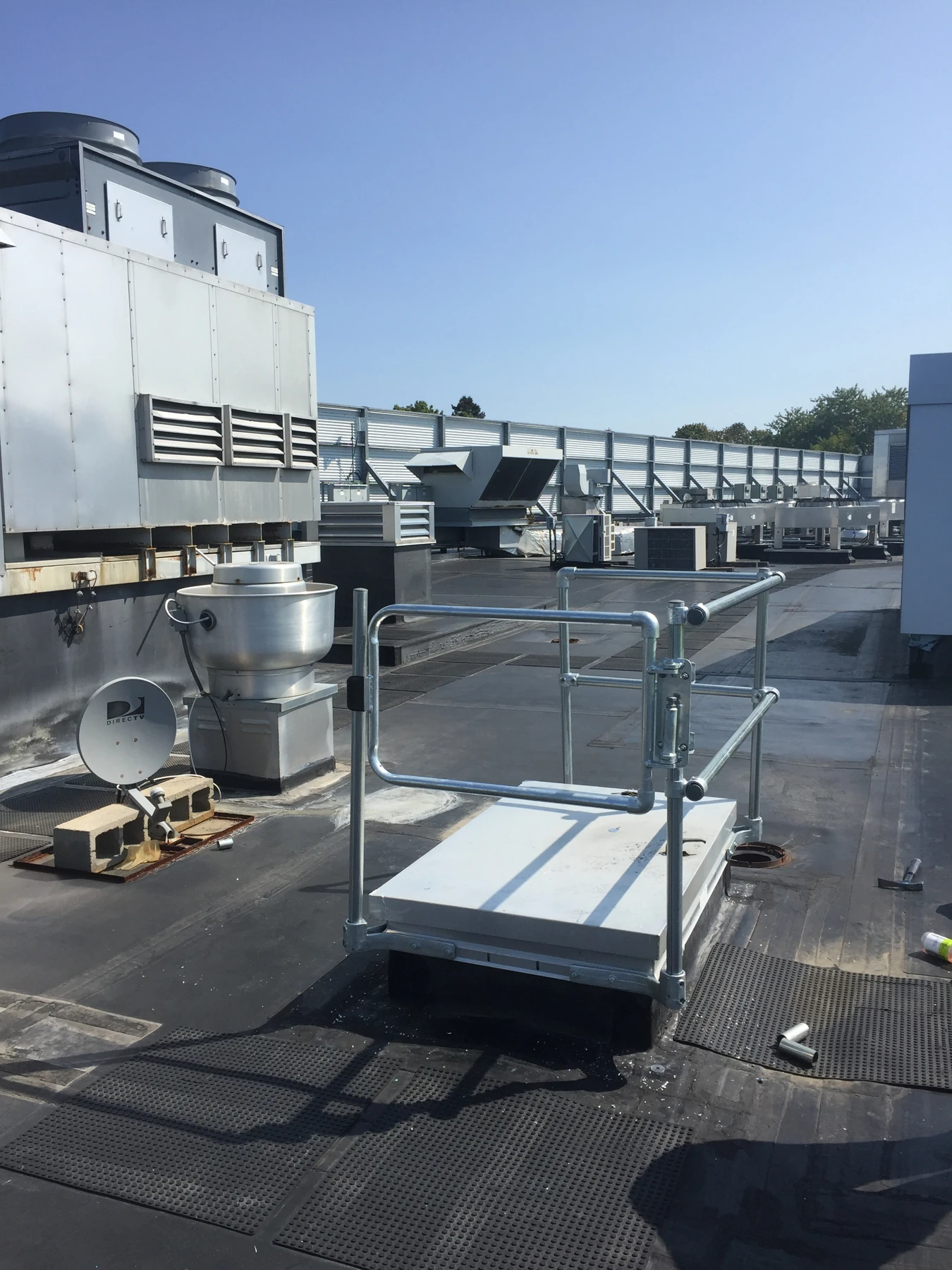 Installed roof hatch with surrounding rails and gate.