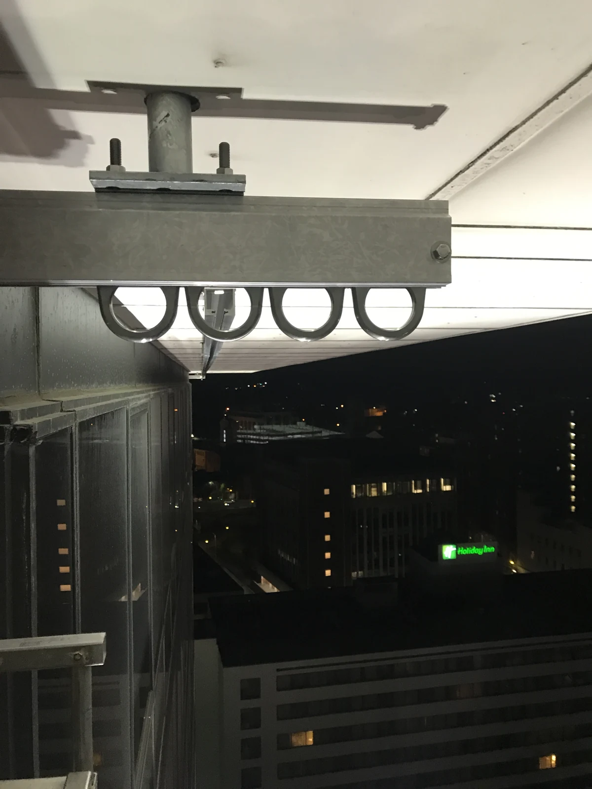 Monorail connection detail beneath a building overhang.