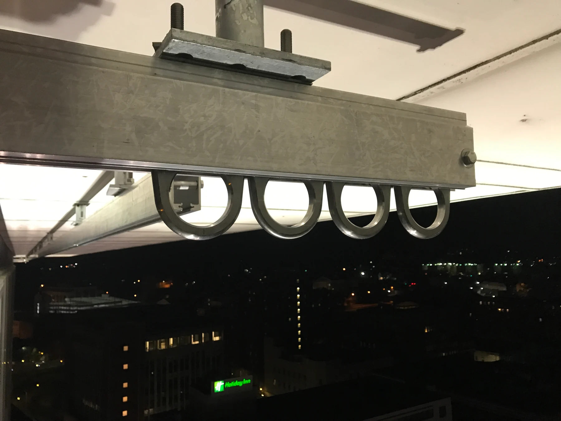 Installed monorail with pendant trolley eyes beneath the enclosed track.