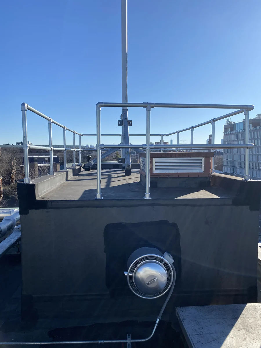 Guardrails around a raised roof access area.