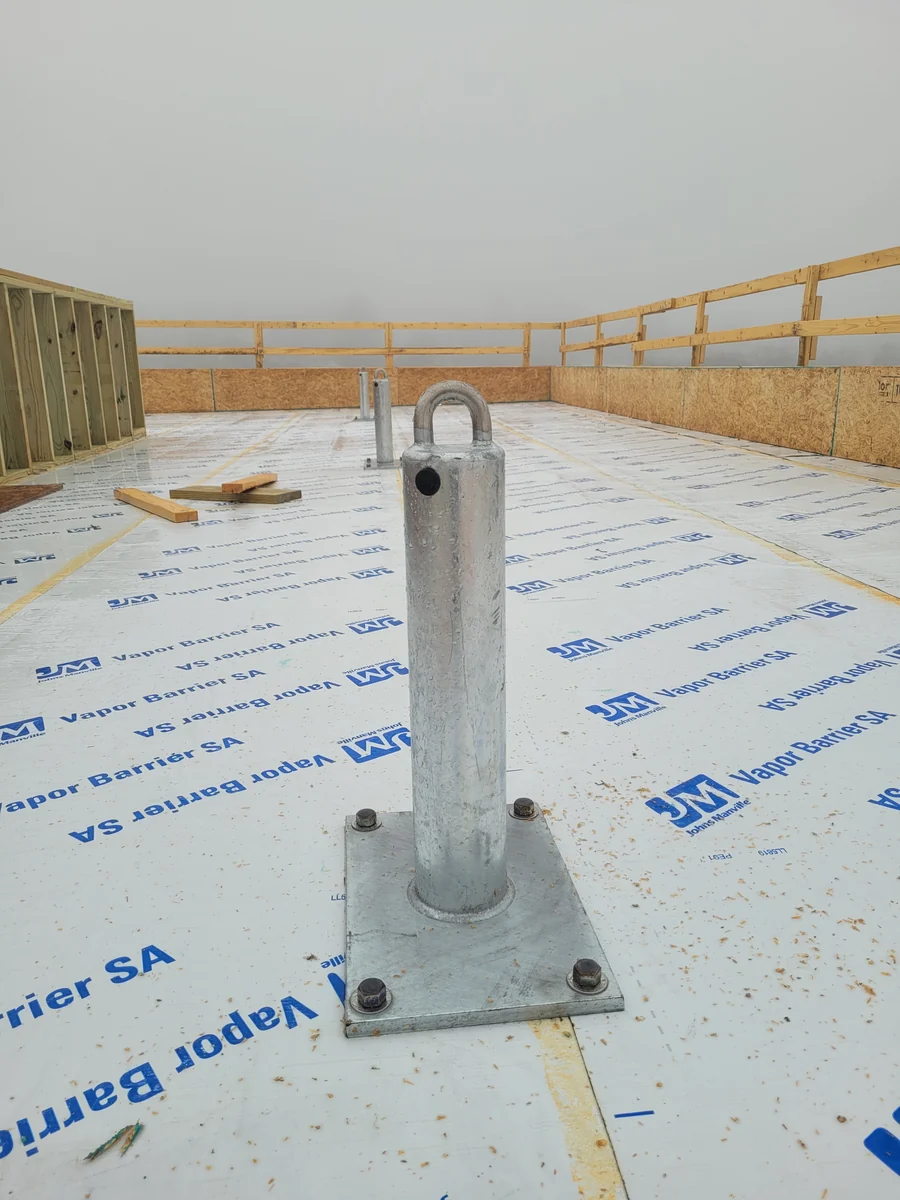Roof-anchor installation during construction.